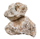 Two irregular porous beige and light brown hole stone rocks with a natural textured surface